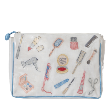 Embroidered makeup bag with a clear protective plastic covering and coordinating beauty accessories for gift ideas for teen girls.
