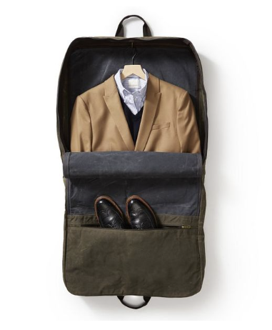 Waxed canvas garment bag with space for a suit and shoes for business travel.